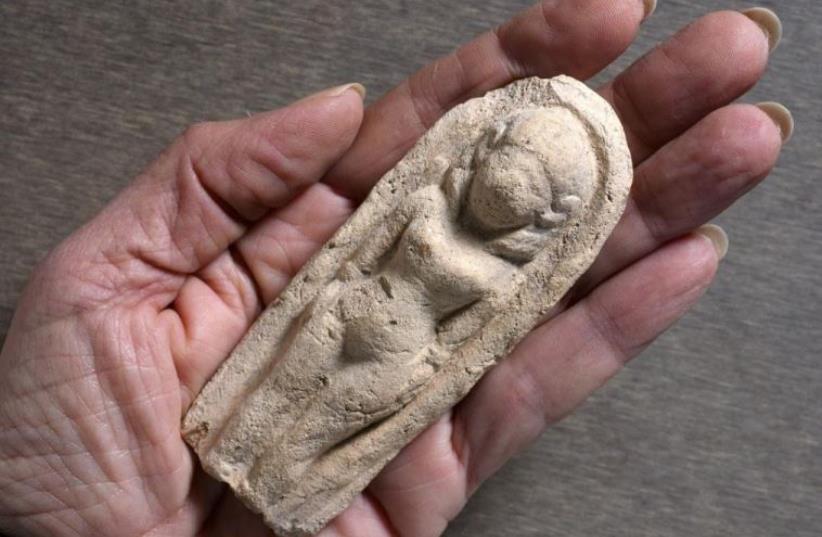 The ancient statuette found by Ori Greenhut in Tel Rehov. (photo credit: MIKI PELEG/IAA)