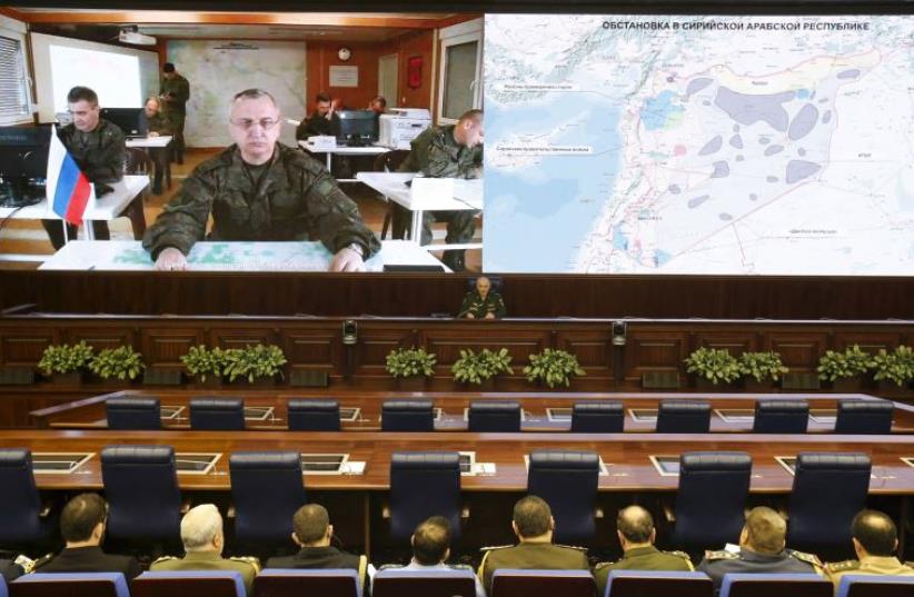 Russian military official Sergei Kuralenko briefs, via video link, foreign military attachés in Moscow on Russia’s suspension of air strikes in a ‘green zone’ in Syria in line with a cessation of hostilities plan, February 27 (photo credit: SHIN BET,REUTERS)