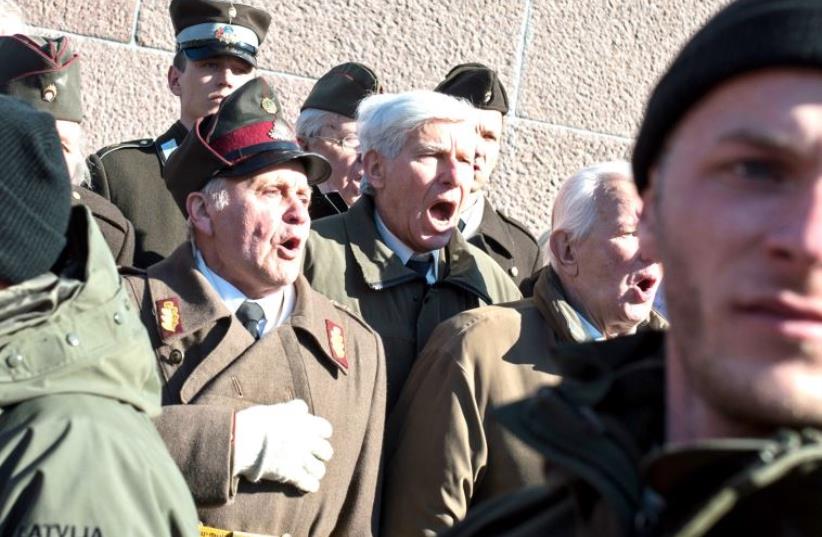 Sympathizers rally at the Freedom Monument in Riga to commemorate the Latvian Legion of the Nazi Waffen-SS, March 2015 (photo credit: ILIYA PITALEV / RIA NOVOSTI / AFP)