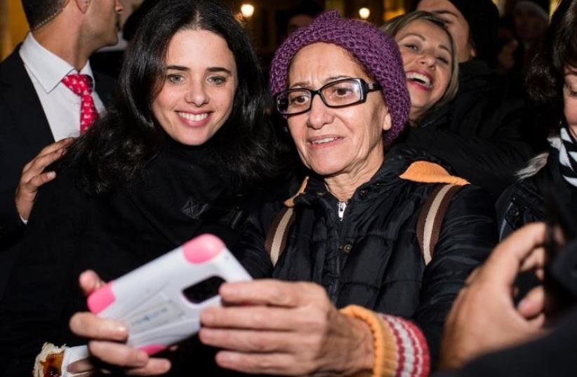 Justice Minister Ayelet Shaked (L) poses for a selfie picture with a member of the Jewish community in Berlin (photo credit: AFP PHOTO)