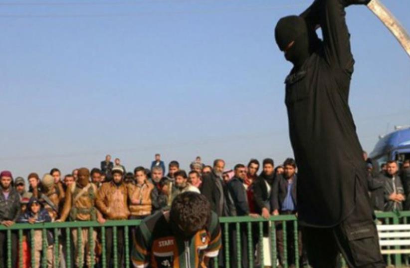 ISIS fighter beheading boy, 16, in Syria (photo credit: ARAB MEDIA)