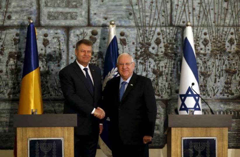 Romanian President Klaus Iohannis (L) shakes hands with his Israeli counterpart Reuven Rivlin as they deliver joint statements before their meeting in Jerusalem March 7, 2016 (photo credit: REUTERS)