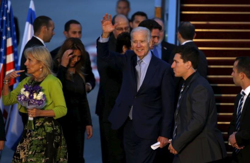  US Vice President Joe Biden (C) waves as he stands next to his wife Jill (L) after they arrive at Ben-Gurion International Airport, March 8, 2016 (photo credit: REUTERS)