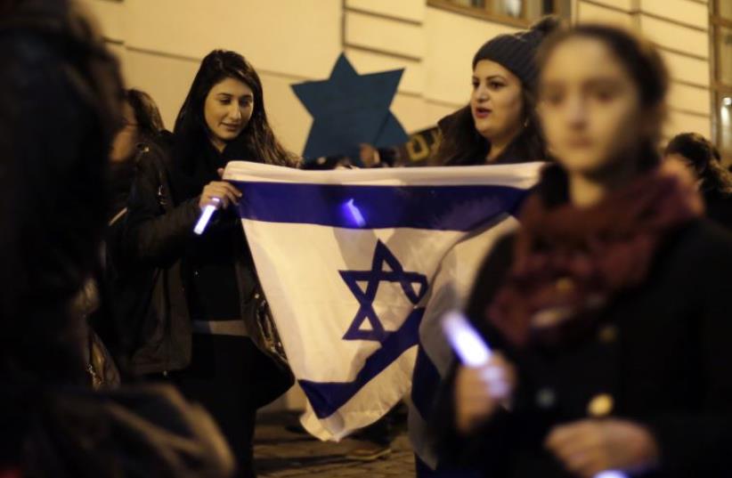 Members of the young Jewish community attend a commemoration ceremony for Holocaust victims in front of the synagogue in Vienna [File] (photo credit: REUTERS)
