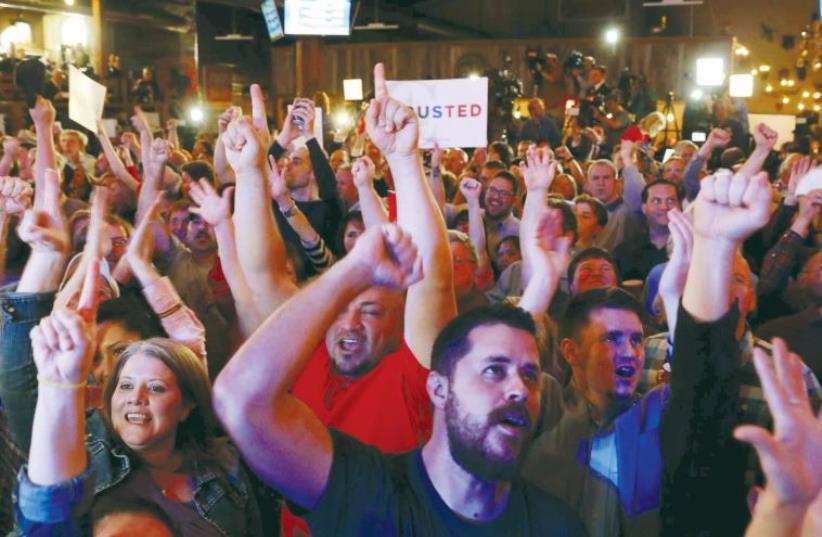 Supporters of US presidential candidate Senator Ted Cruz cheer as they watch Super Tuesday primary and caucus voting results at a campaign rally (photo credit: REUTERS)