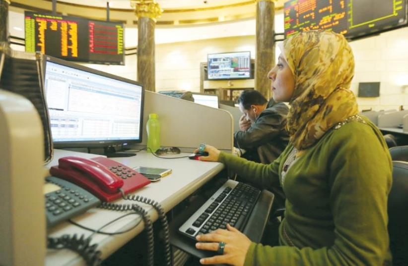 A trader works at the Egyptian stock exchange in Cairo on Tuesday (photo credit: REUTERS)