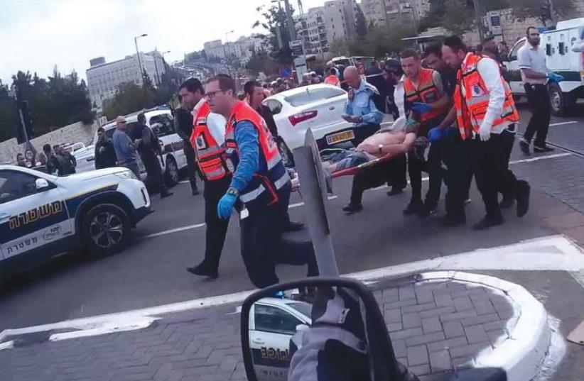 UNITED HATZALAH volunteers evacuate a wounded victim from a terrorist attack in Jerusalem. (photo credit: Courtesy)