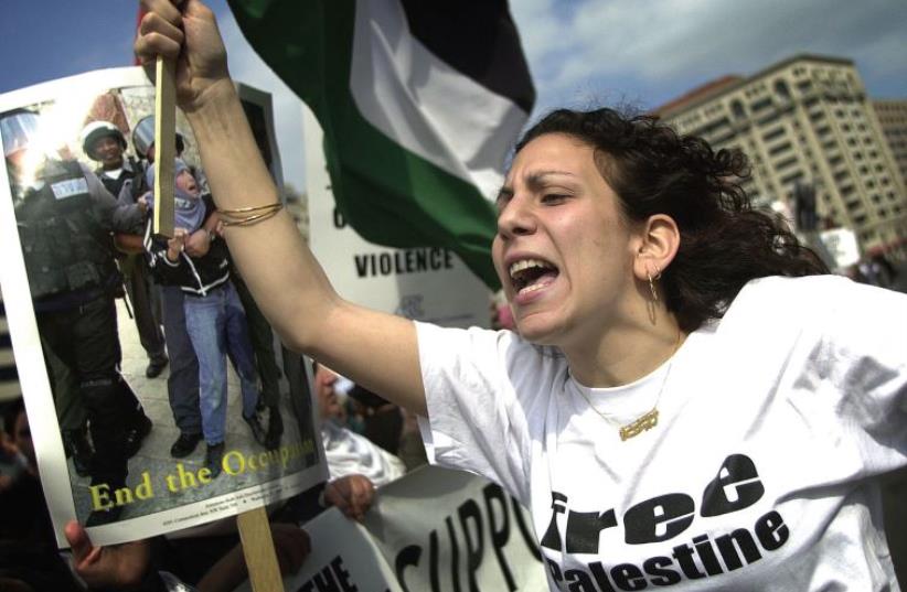 Zeina Ashrawi, of the Students for Justice in Palestine Society of George Mason University, participates in an anti-Israel rally in Washington, DC (photo credit: JIM WATSON / AFP)