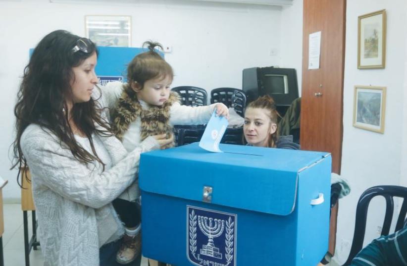A WOMAN casts a ballot in the March 2015 national election (photo credit: MARC ISRAEL SELLEM)