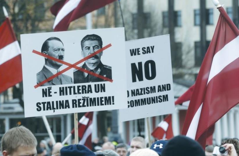 PEOPLE PARTICIPATE in the annual procession commemorating the Latvian Waffen-SS (Schutzstaffel) unit in Riga (photo credit: REUTERS)