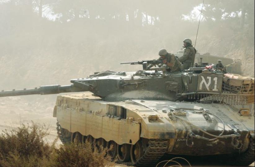 An Israeli tank moves along the border with Lebanon in August 2006 (photo credit: REUTERS)