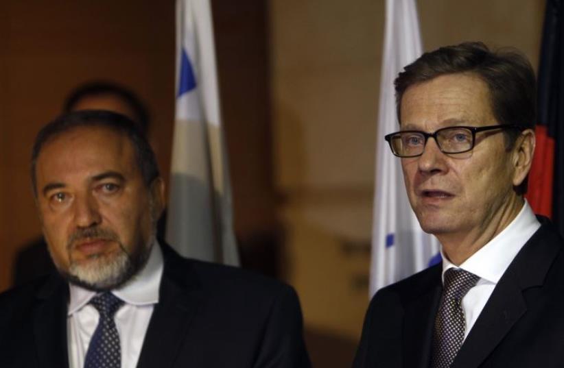 Former foreign minister Avigdor Lieberman (L) stands next to his German counterpart Guido Westerwelle in Jerusalem (photo credit: REUTERS)