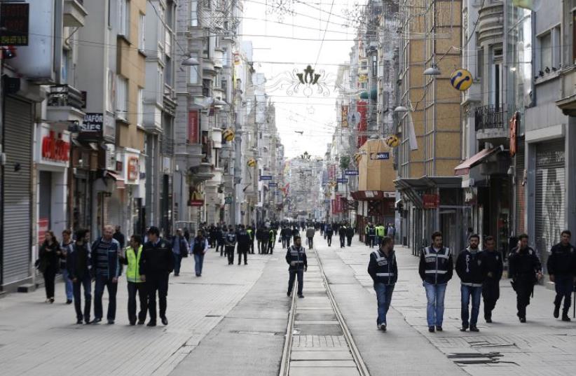 Plain clothes police walk on the main pedestrian street of Istiklal in central Istanbul during a May Day demonstration in Istanbul May 1, 2014 (photo credit: REUTERS)