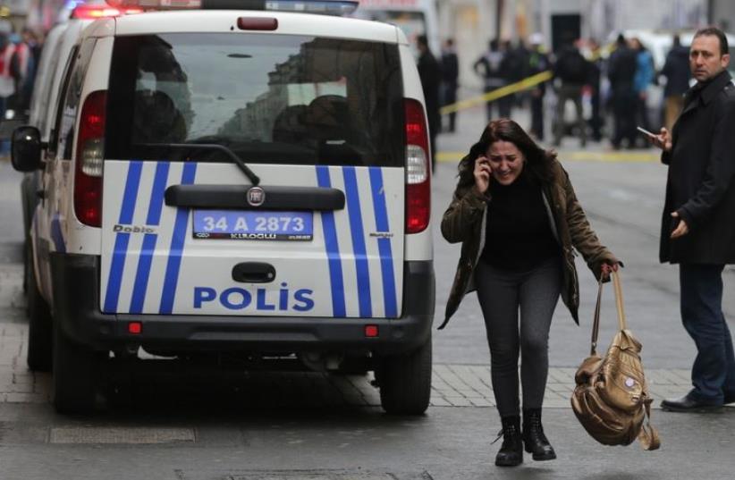 A woman reacts following a suicide bombing in a major shopping and tourist district in Istanbul