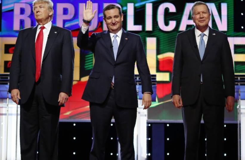 Republican US presidential candidates (L-R) Donald Trump, Ted Cruz and John Kasich stand together at a Republican candidates debate on March 10 (photo credit: REUTERS)