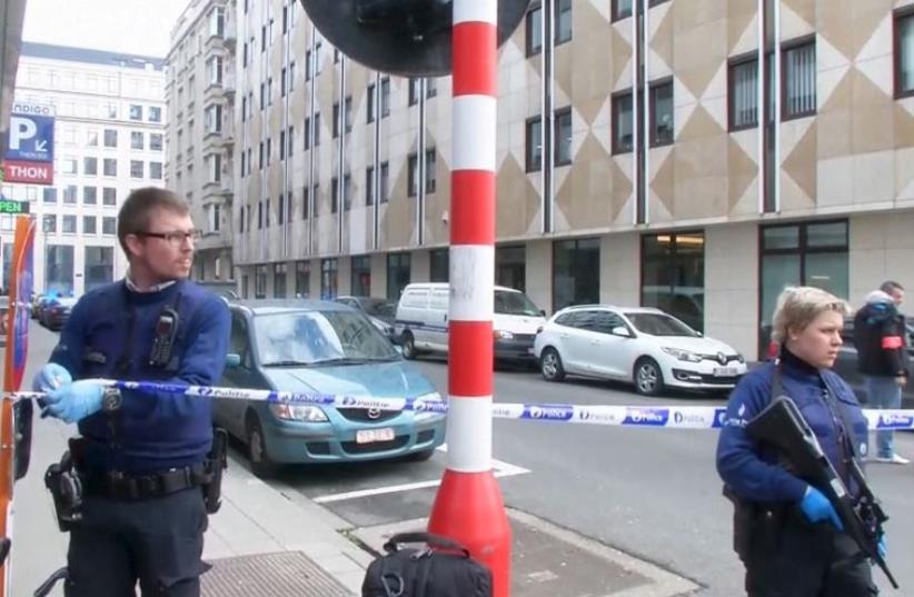 Emergency personnel are seen at the scene of a blast outside a metro station in Brussels, in this still image taken from video on March 22, 2016 (photo credit: REUTERS)