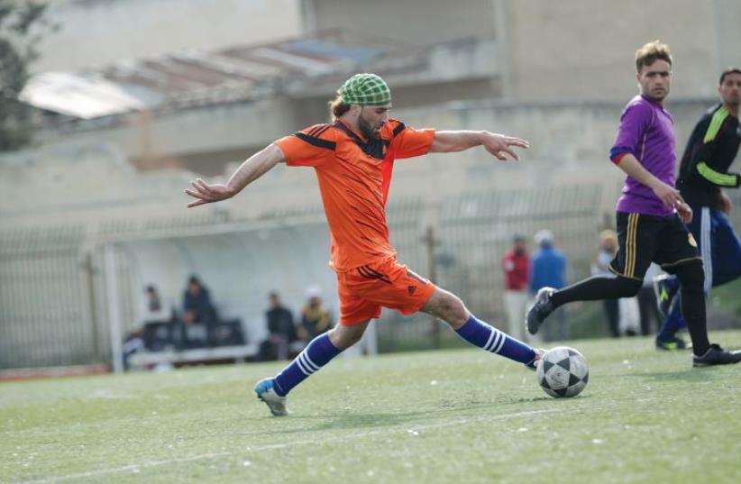 The Syrian town of Marat Numan in Idlib province hosts a local soccer tournament on March 19 (photo credit: KHALIL ASHAWI / REUTERS)