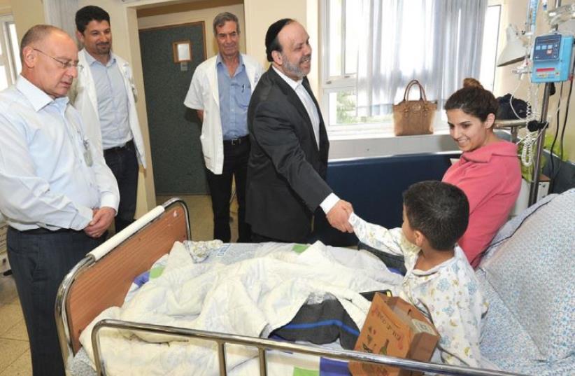 Religious Services Minister David Azoulay visits children at Nahariya’s Western Galilee Hospital to bring them good cheer for Purim (photo credit: RONI ALBERT)