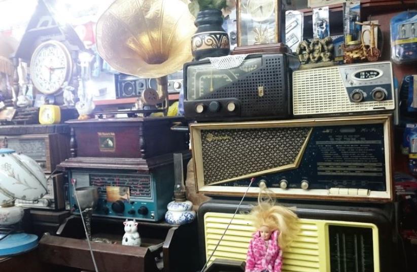 A collection of items including vintage clocks, radios and a gramophone (photo credit: YAEL BRYGEL)
