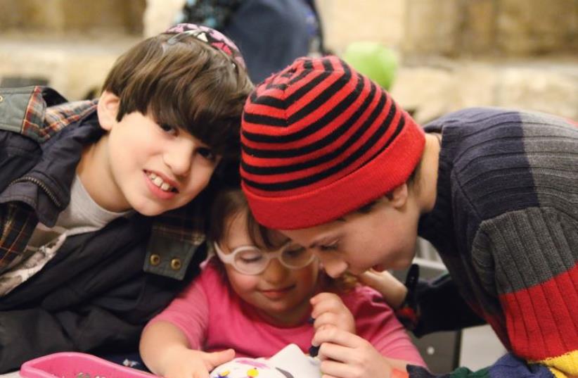 Decorating masks in time for Purim, at the first Meet in the Tower event for families with children with additional needs at the Tower of David Museum (photo credit: RICKY RACHMAN)