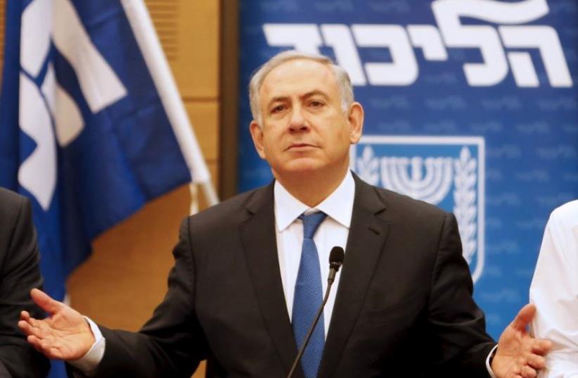  Prime Minister Benjamin Netanyahu (C) attends a meeting of the Likud party in the Israeli parliament in Jerusalem (photo credit: REUTERS)
