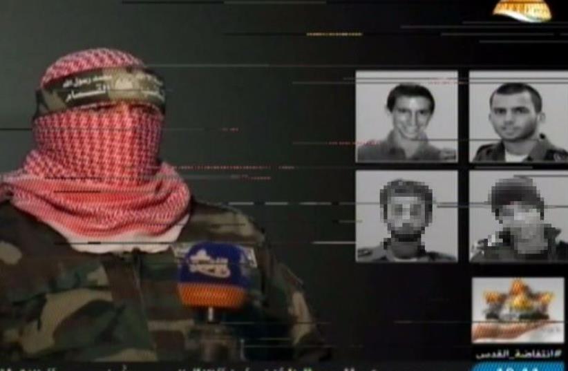 Al Aksa TV footage of Hamas military wing showing images of four Israeli "POWs" (photo credit: ARAB MEDIA)
