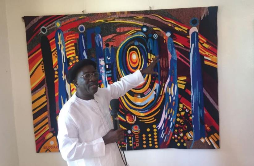 Kasse, a local artist shows some of his recent work at his studio in Dakar (photo credit: SETH J. FRANTZMAN)