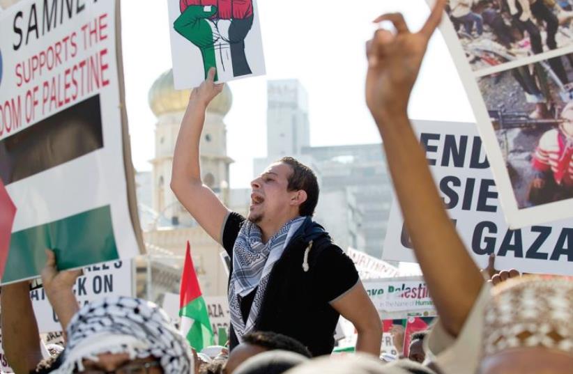 PRO-PALESTINIAN DEMONSTRATORS protest against Israel’s military action in Gaza, after Friday prayers in Durban in 2014. (photo credit: REUTERS)