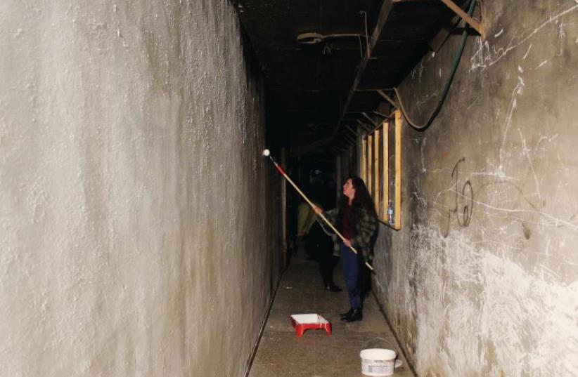 Emunah College third-year art students prepare and paint the pedestrian tunnel (photo credit: BARAK COHEN)