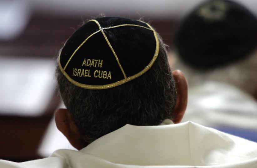 MEN OF the Cuban Jewish community attend a service at the Orthodox Adath Israel synagogue in Old Havana (photo credit: REUTERS)