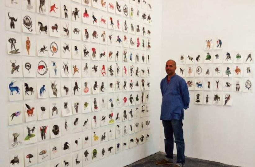 Chanchal Banga alongside his exhibition at the Artist’s House gallery in north Tel Aviv, which examined a very Indian animal – monkeys (photo credit: VARDA CARMELI)