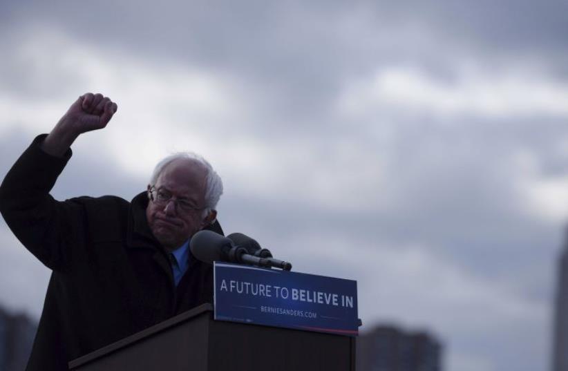 The Empire State Building is seen in the background from Transmitter Park as U.S. Democratic presidential candidate and Senator Bernie Sanders gestures during a campaign rally in the Brooklyn borough of New York April 8, 2016.  (photo credit: REUTERS)