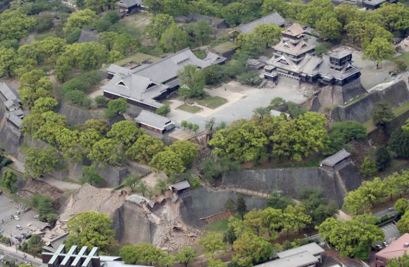 Damaged Kumamoto Castle caused by earthquakes is seen in Kumamoto, southern Japan, in this photo taken by Kyodo April 16, 2016.  (photo credit: REUTERS)