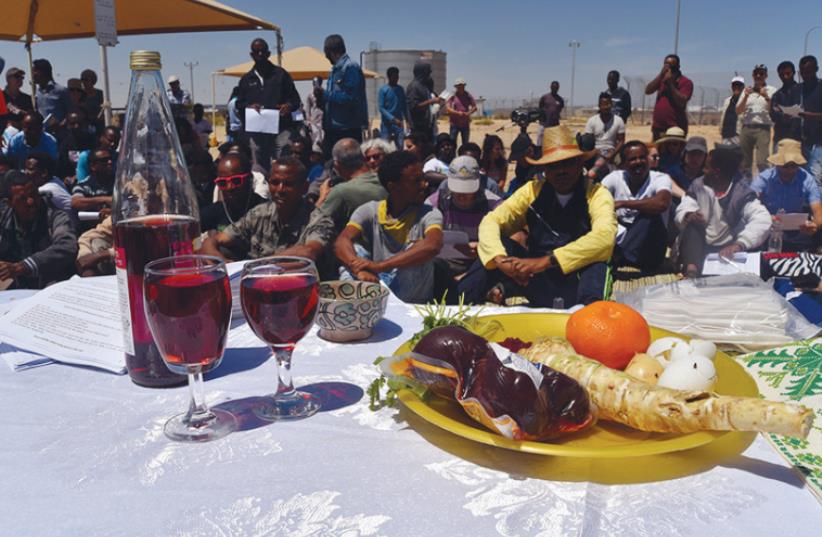 AFRICAN DETAINEES at the Holot detention center in the Negev celebrate a pre-Passover Seder on Friday initiated by Rabbis for Human Rights and Right Now: Advocates for Asylum Seekers in Israel (photo credit: RABBIS FOR HUMAN RIGHTS‏)