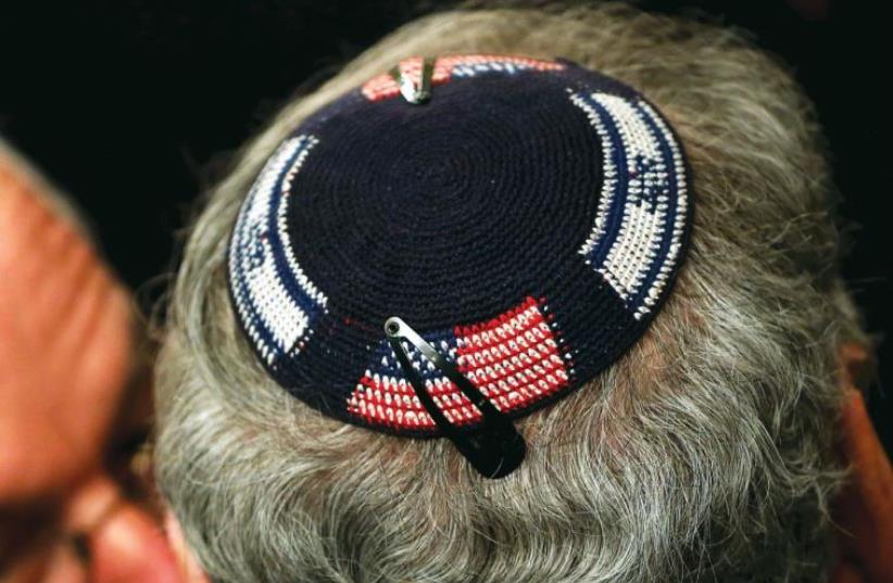 A man wears a kippa embroidered with US and Israeli flags (photo credit: REUTERS)