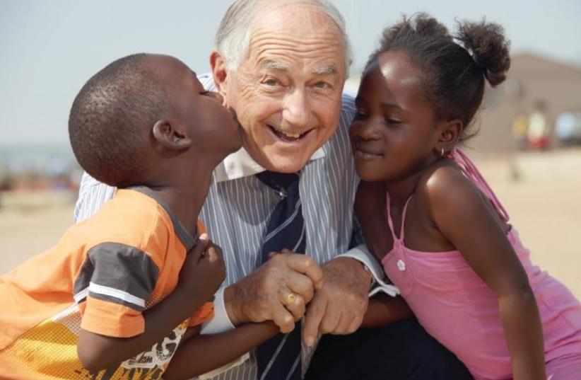 BERTIE LUBNER with two of many disadvantaged children he helped in South Africa (photo credit: Courtesy)