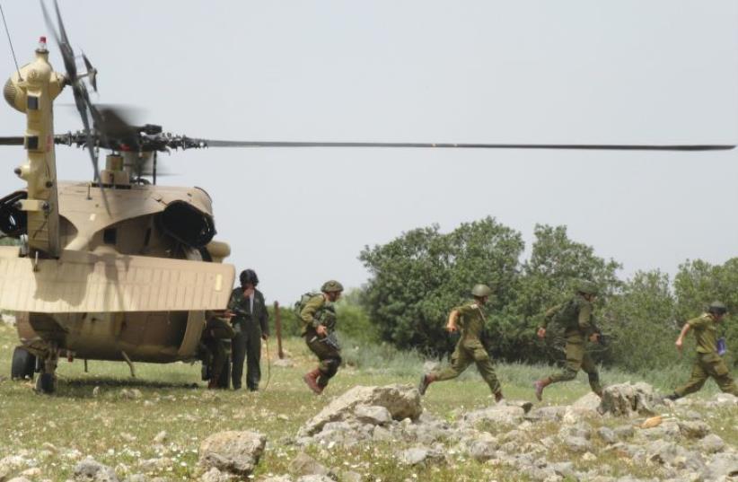 NAHAL INFANTRY soldiers take part in a drill with helicopters earlier this month in the North (photo credit: IDF SPOKESPERSON'S UNIT)