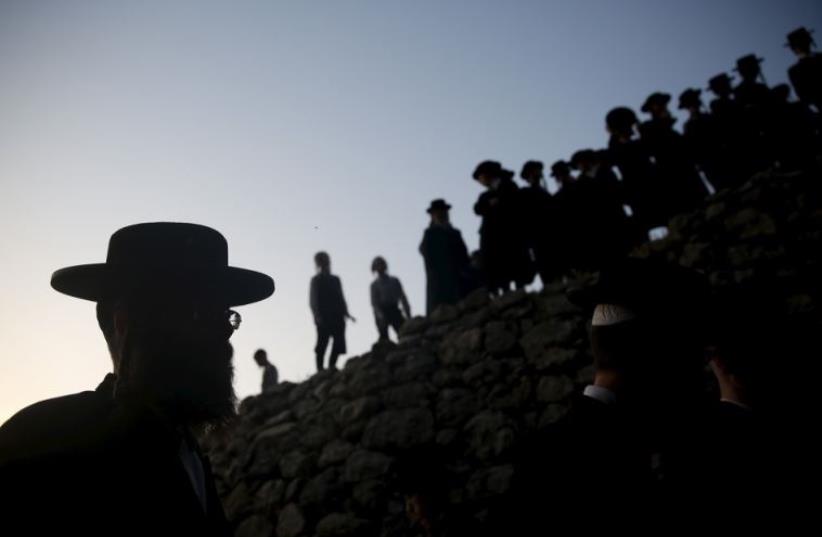 Ultra-Orthodox Jews take part in the 'Mayim Shelanu' ceremony to collect water from a natural spring to make matza (photo credit: REUTERS)