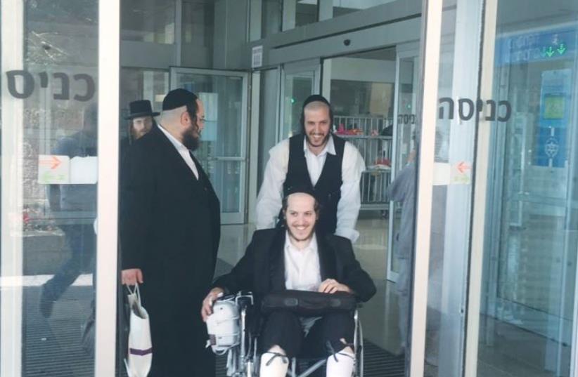 CHAIM WINTERNITZ is wheeled out of Jerusalem’s Hadassah-University Medical Center in Ein Kerem (photo credit: HADASSAH)