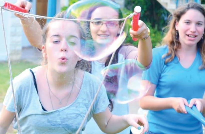CAMPERS AT Camp Koby enjoy a bubble-making workshop recently at their home base in Kibbutz Yehiam (photo credit: DANIEL MANDELL)