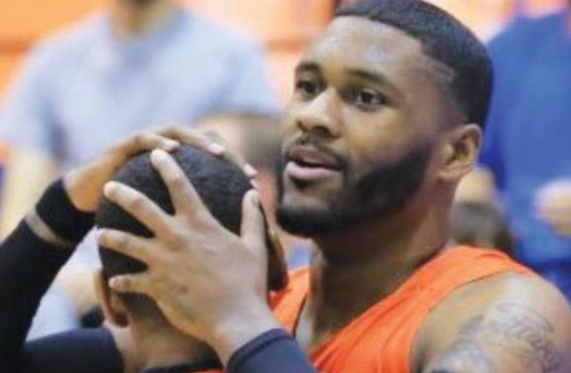 Maccabi Rishon Lezion forward Darryl Monroe (right) embraces teammate Mark Lyons during last night’s 95-82 win in Herzliya, with the two combining for 35 points. (photo credit: MACCABI RISHON LEZION)