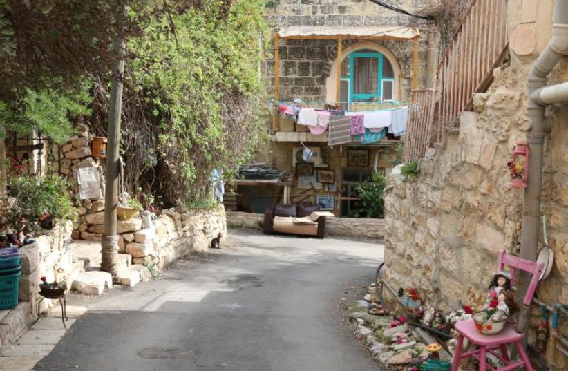 Dwellings of stone – and a doll – on Ha’ahayot Street. (photo credit: SHMUEL BAR-AM)