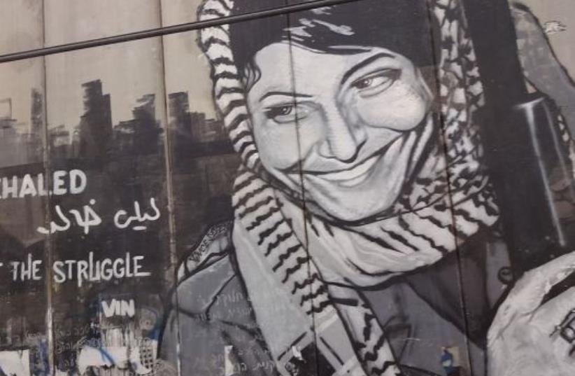 Graffiti depicting the PFPL plane hijacker Leila Khaled on the security barrier near Bethlehem (photo credit: Wikimedia Commons)