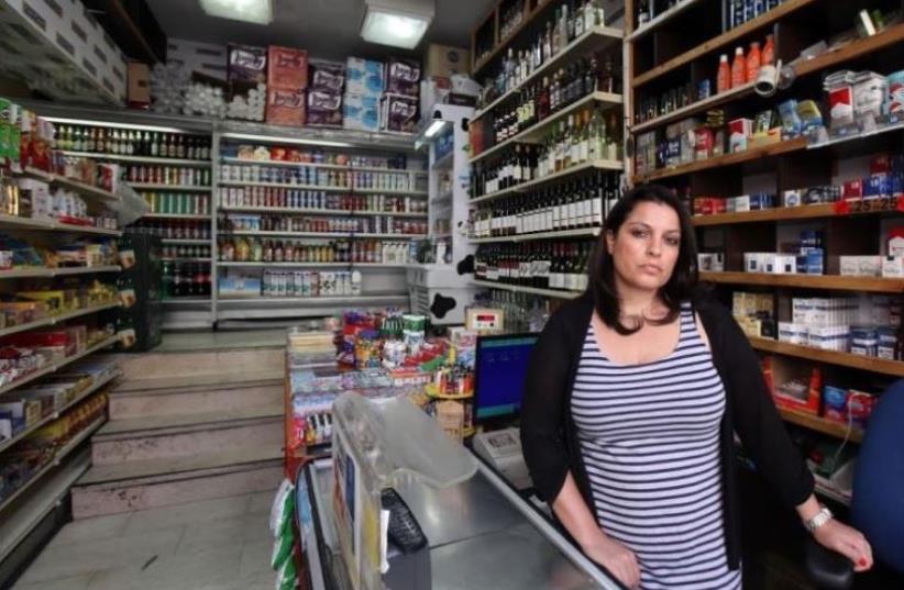 An employee of Makolet 24-hour Market on Hillel Street, one of the eight markets being forced by the Jerusalem Municipality to close during Shabbat. (photo credit: MARC ISRAEL SELLEM)