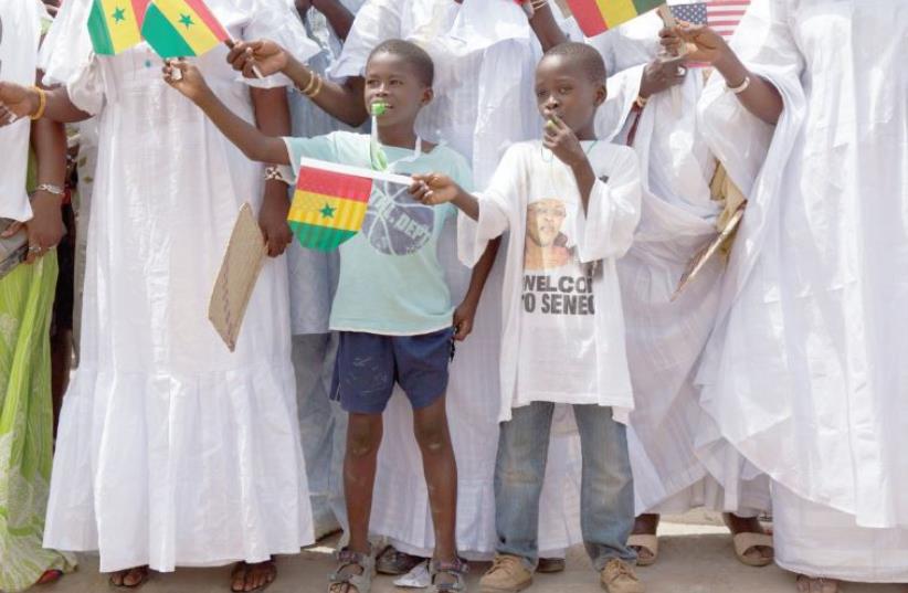YOUNG SENEGALESE welcome US President Barack Obama to a school in Senegal in 2013 (photo credit: REUTERS)