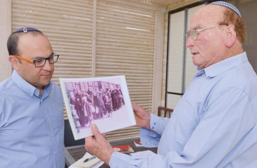 Elipur in action with a project participant, Holocaust survivor David Laitner (photo credit: COURTESY JUDITH HARPAZ AND MEIR ELIPUR)