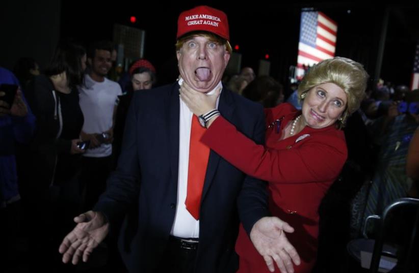 Supporters who came to a Hillary Clinton rally in costume as Republican presidential candidate Donald Trump (L) and as Mrs. Clinton (R) clown around  in Miami (photo credit: REUTERS)