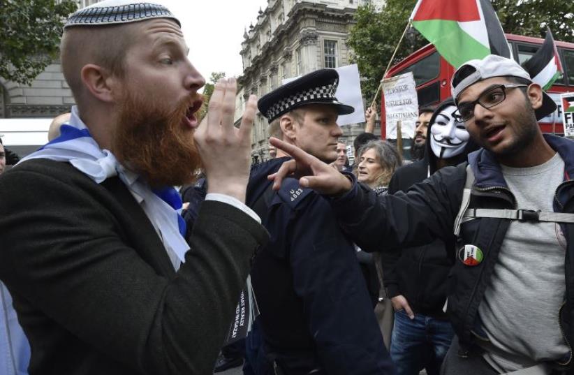 Supporters of Israel and the Palestinians argue during a demonstration in London (photo credit: REUTERS)