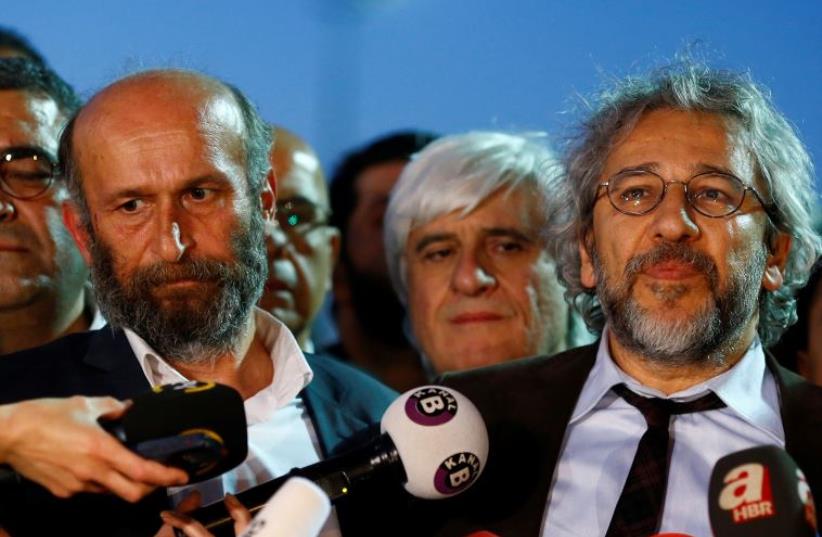 Can Dundar (R), editor-in-chief of Cumhuriyet, accompanied by his Ankara bureau chief Erdem Gul (photo credit: REUTERS)