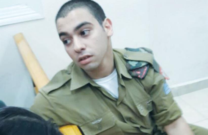 SGT. ELOR AZARIA relaxes for a moment at the beginning of his manslaughter trial yesterday at Jaffa Military Court (photo credit: YONAH JEREMY BOB)